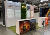 Friarwood exhibition stand, back wall with artificial shrubbery on back wall and neon lighting