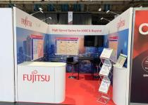 Fujitsu exhibition stand, 3 graphic walls with a tv screens, reception counter and a literature rack