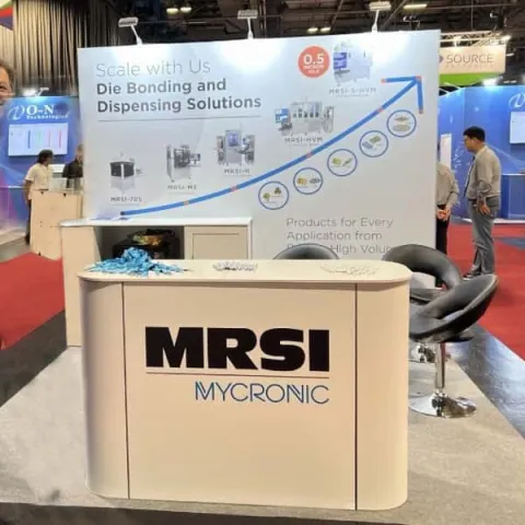 Micronic exhibition stand - single back wall with large front counter, table and chairs in-between