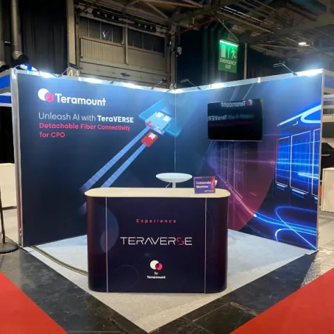 Teramount's exhibition stand - 2 walls, with a large counter in front and a poseur table in between